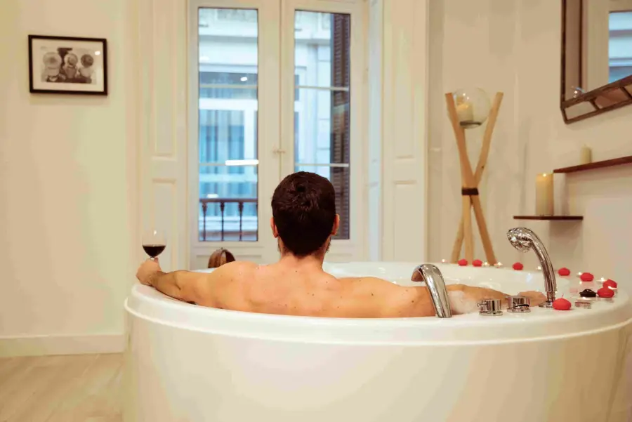 Guest relaxing in a jacuzzi tub