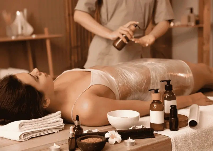 Body wrap therapy with scrubs and oils